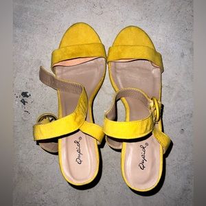 worn yellow heels